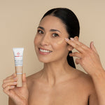 freezeframe PRO-COLLAGEN SUNCEUTICAL product applied to cheek by woman who is holding product tube, showing skin-perfecting finish