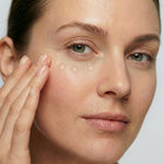 Woman applying freezeframe REVITALEYES gel treatment to the under-eye area