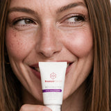 Woman holding freezeframe REVITALEYES treatment for wrinkles, puffiness and dark circles